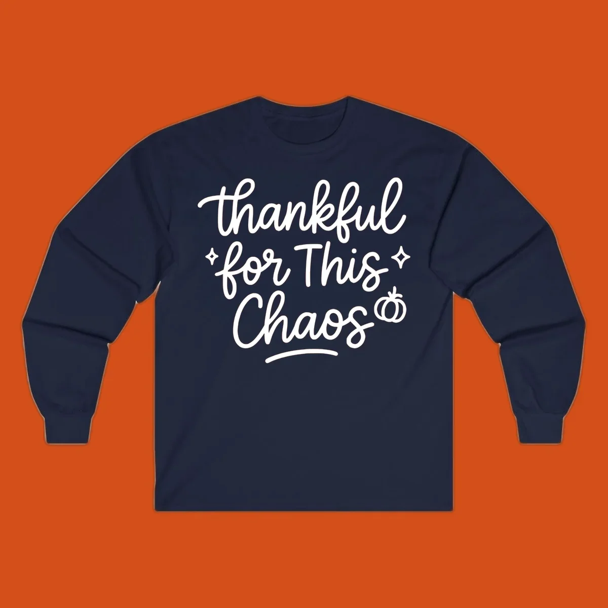 White script text 'thankful for This Chaos' with sparkles and a pumpkin on a black background.
