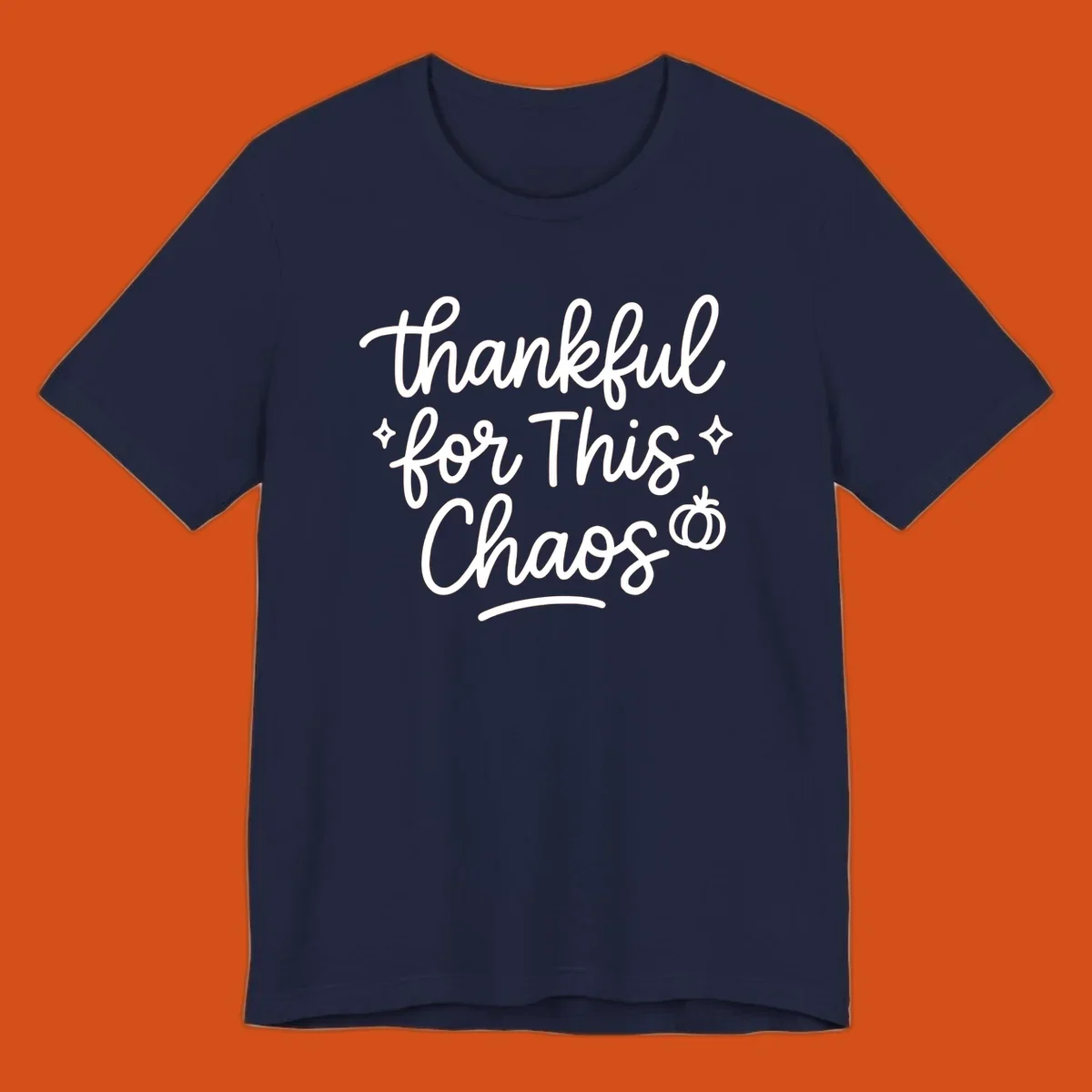 White script text 'thankful for This Chaos' with sparkles and a pumpkin on a black background.