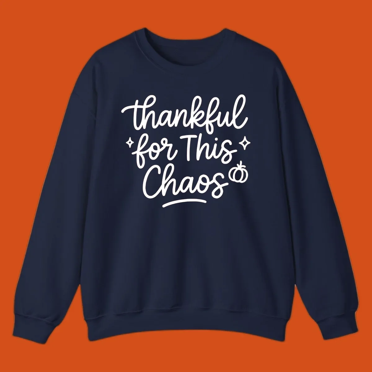 White script text 'thankful for This Chaos' with sparkles and a pumpkin on a black background.