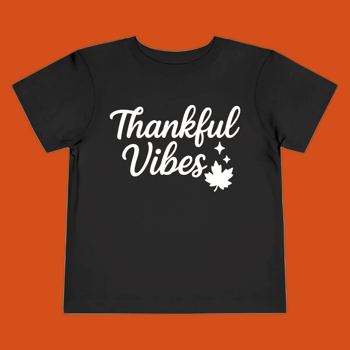 Thankful Vibes text with fall maple leaf and sparkles graphic.