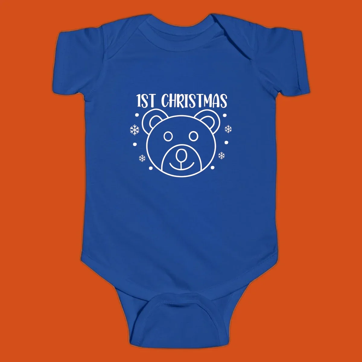 Baby's first christmas bear graphic with text and snowflakes.