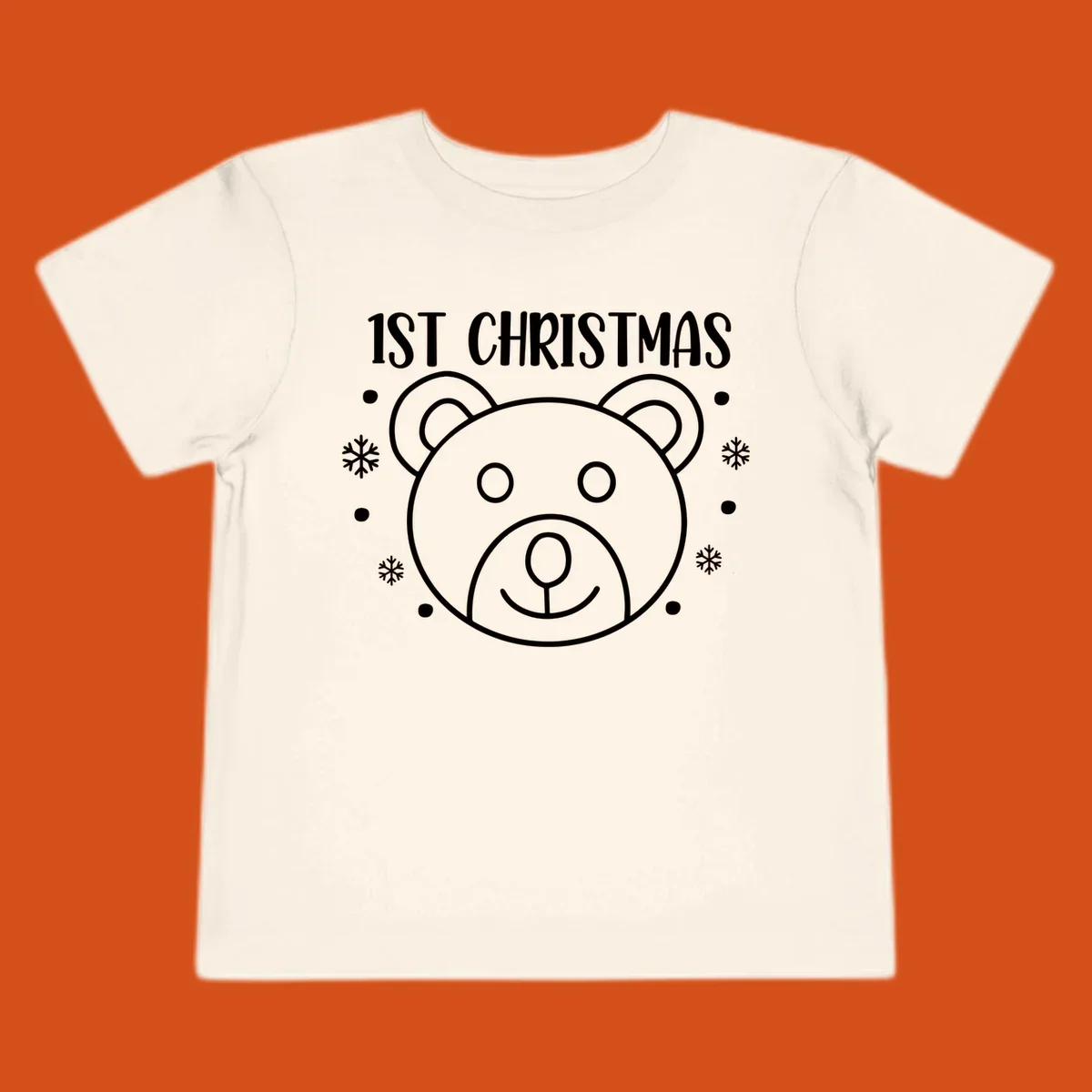 Baby's first christmas bear graphic with text and snowflakes.