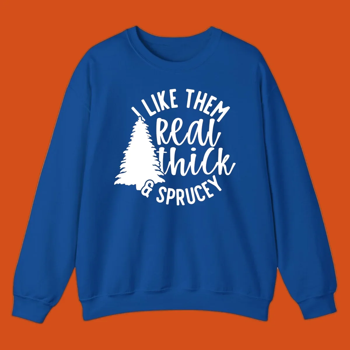 Illustration of a Christmas tree with text 'I like them real thick & sprucey', for thick-sprucey-christmas designs.
