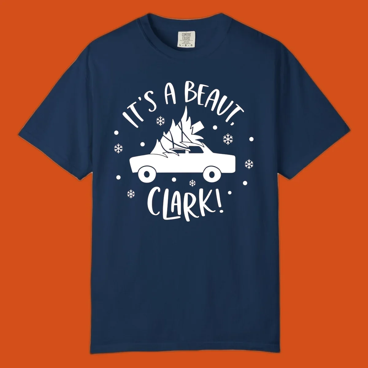 White silhouette of a car with a Christmas tree on top, and text 'IT'S A BEAUT, CLARK!'