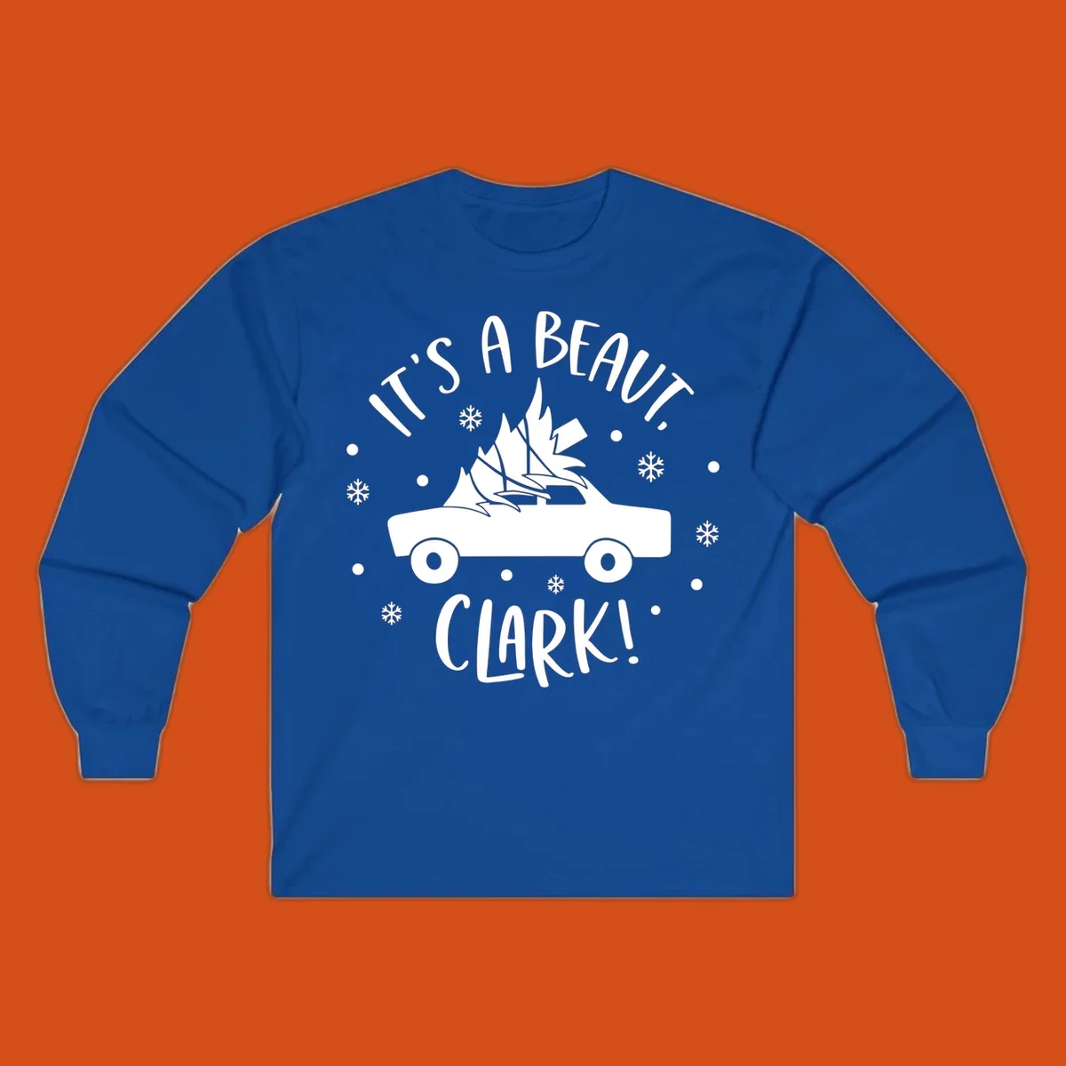 White silhouette of a car with a Christmas tree on top, and text 'IT'S A BEAUT, CLARK!'