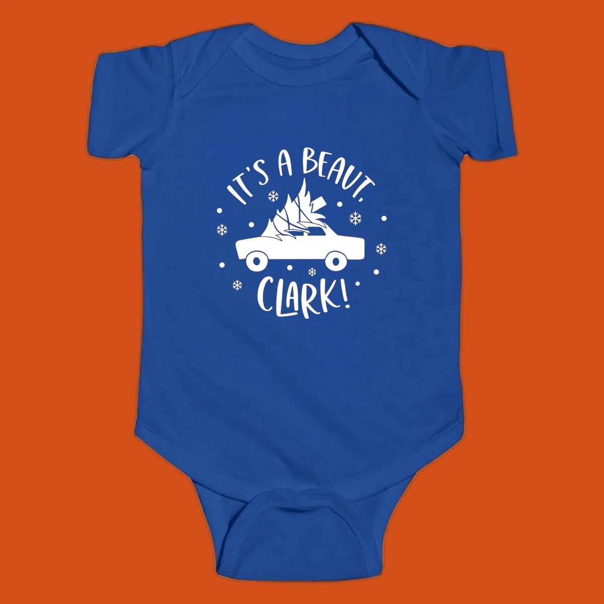 White silhouette of a car with a Christmas tree on top, and text 'IT'S A BEAUT, CLARK!'