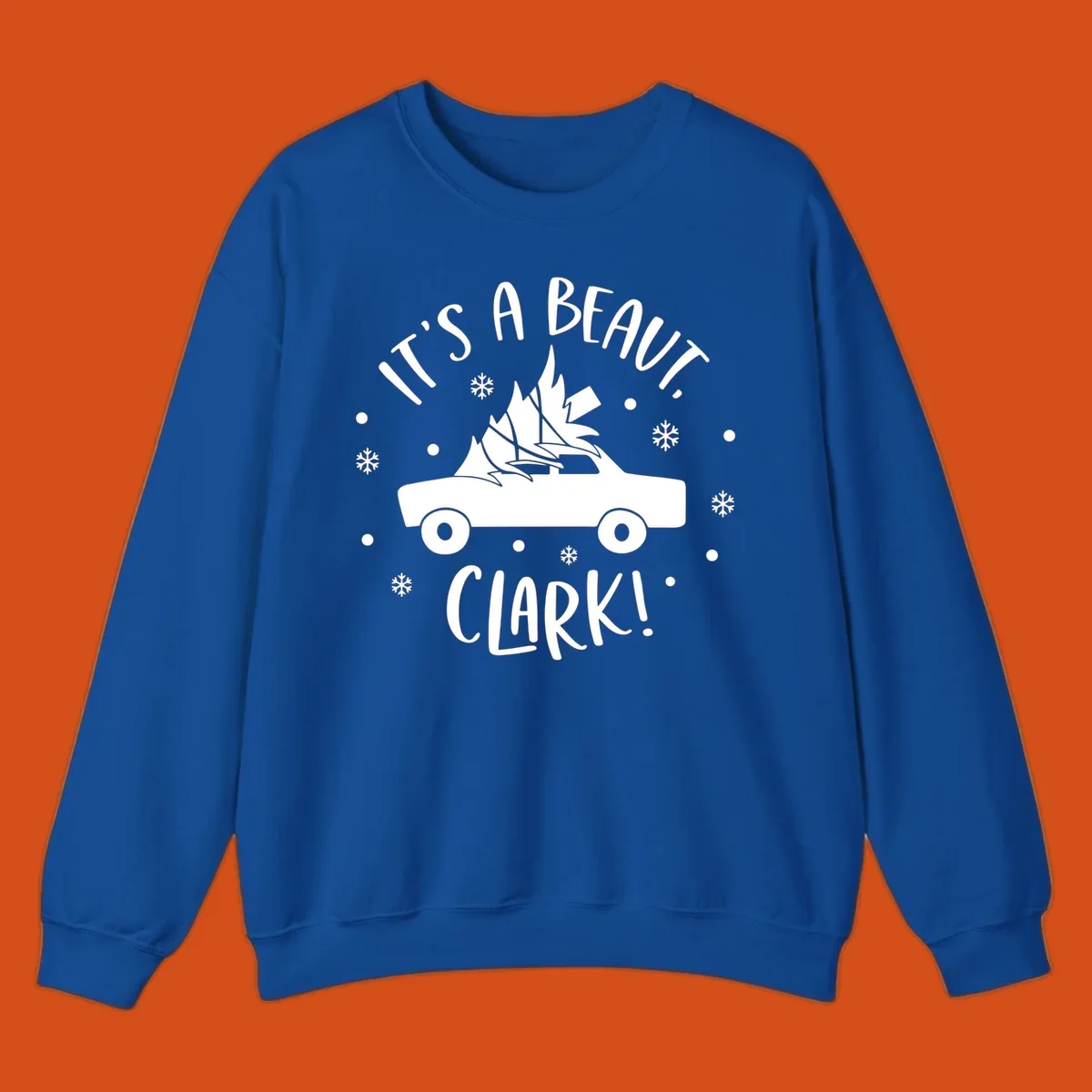 White silhouette of a car with a Christmas tree on top, and text 'IT'S A BEAUT, CLARK!'