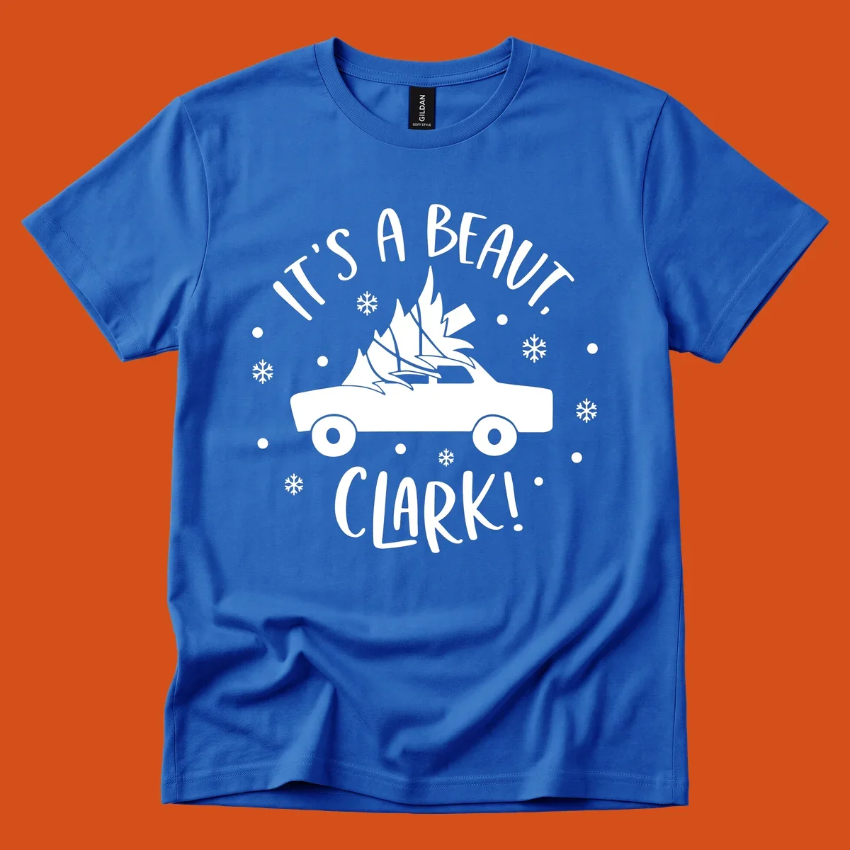 White silhouette of a car with a Christmas tree on top, and text 'IT'S A BEAUT, CLARK!'