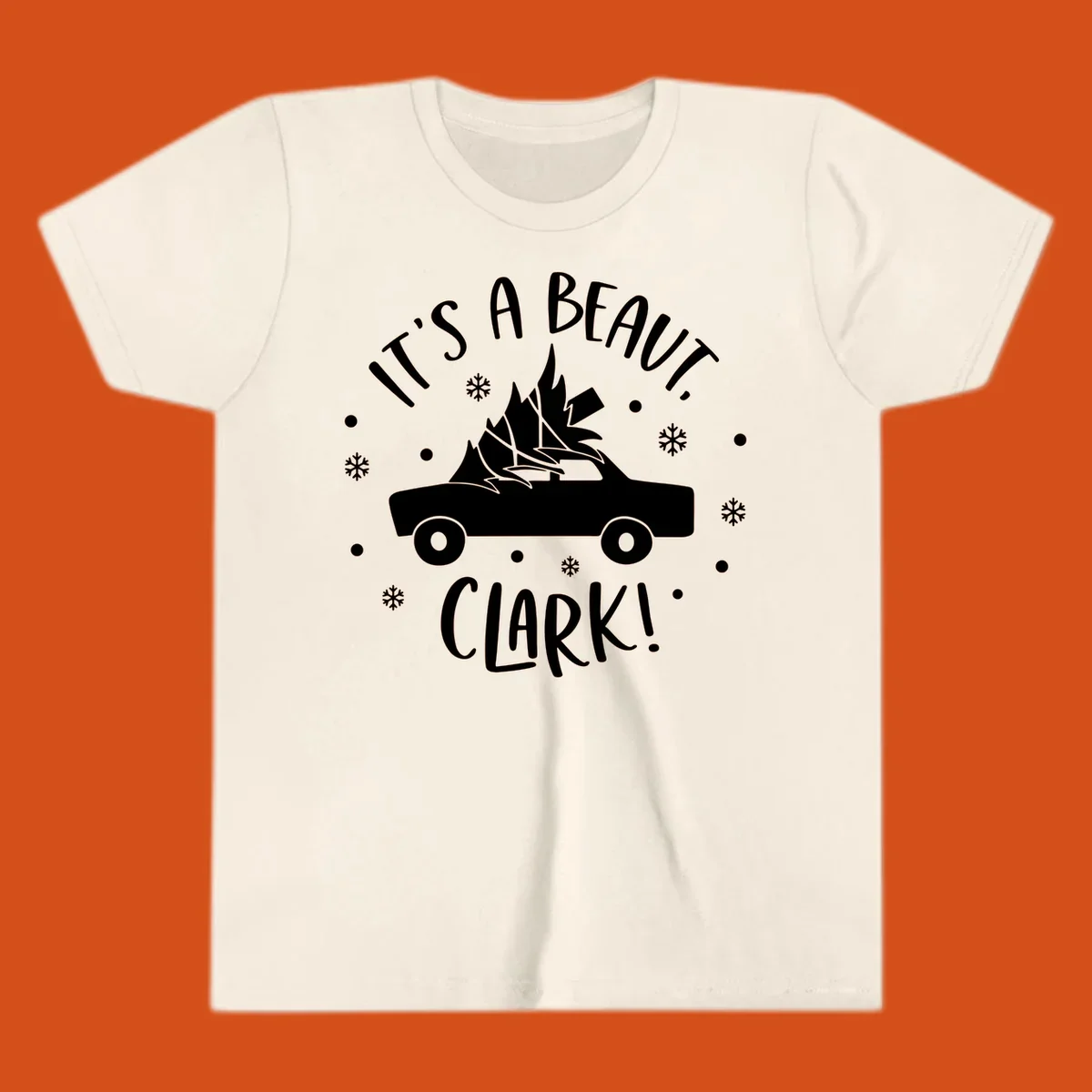 White silhouette of a car with a Christmas tree on top, and text 'IT'S A BEAUT, CLARK!'