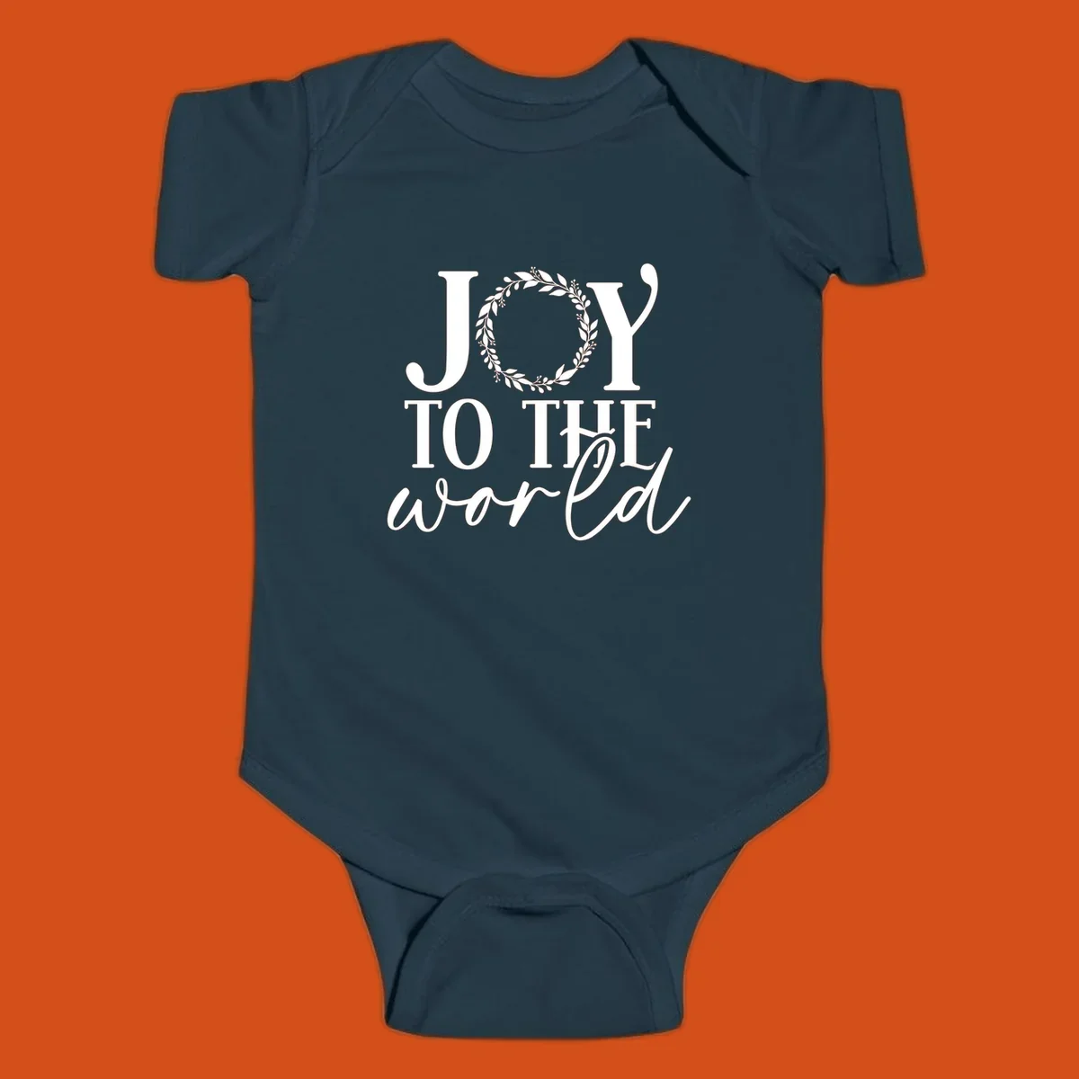 Joy to the World Christmas text design with a wreath replacing the letter O. White text on black background.