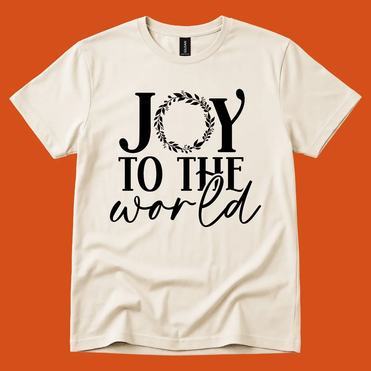 Joy to the World Christmas text design with a wreath replacing the letter O. White text on black background.