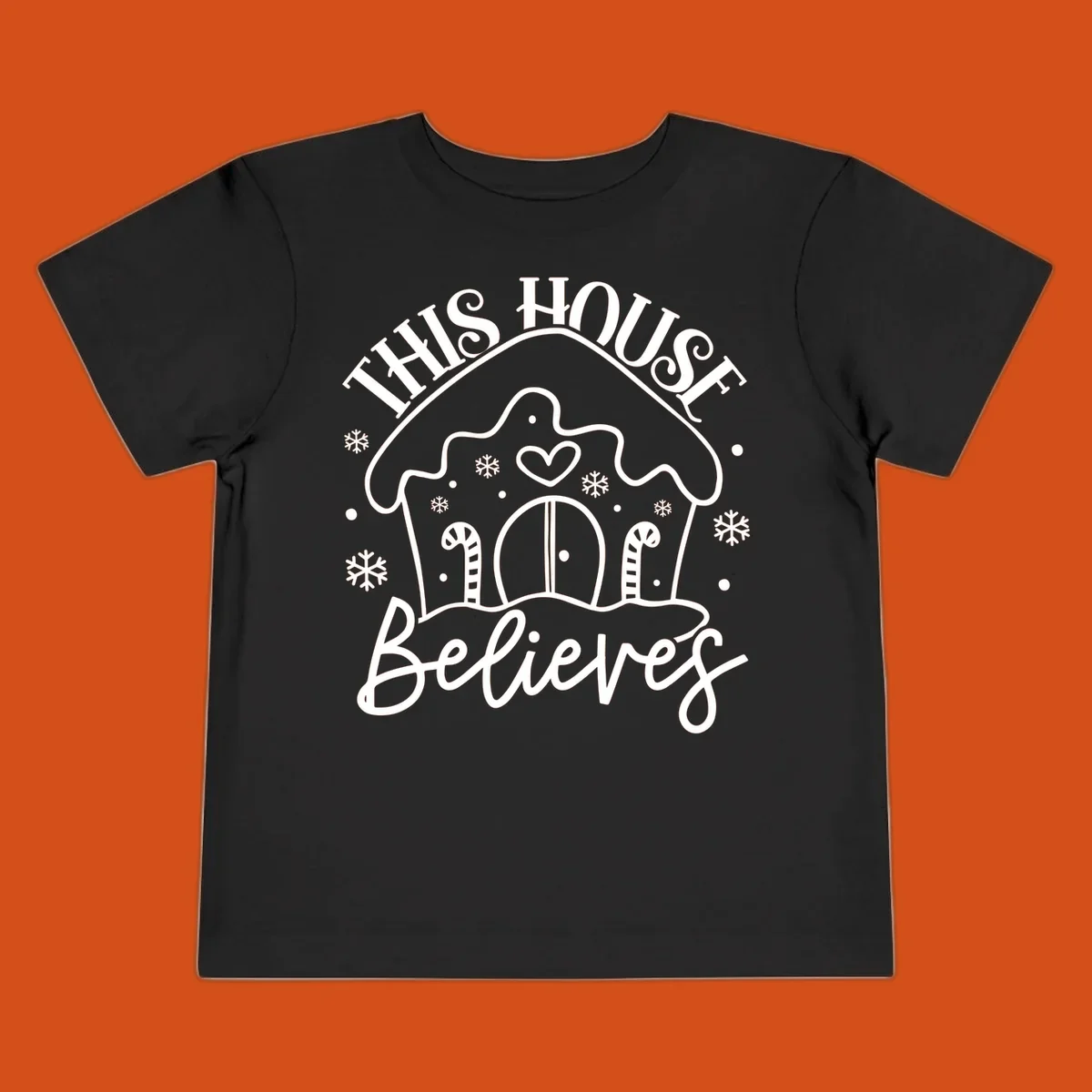 Gingerbread house graphic with 'This House Believes' text for Christmas.