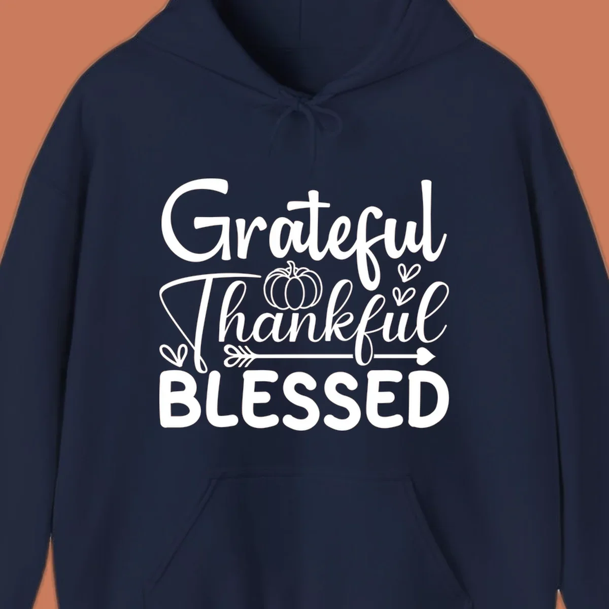 Grateful Thankful Blessed typography design with pumpkin, hearts, and arrow.