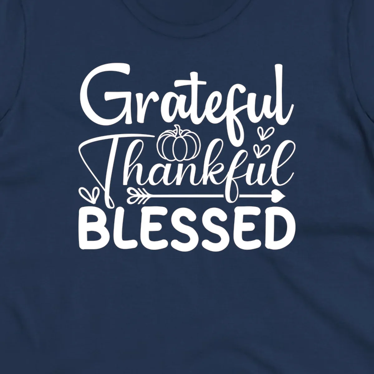 Grateful Thankful Blessed typography design with pumpkin, hearts, and arrow.