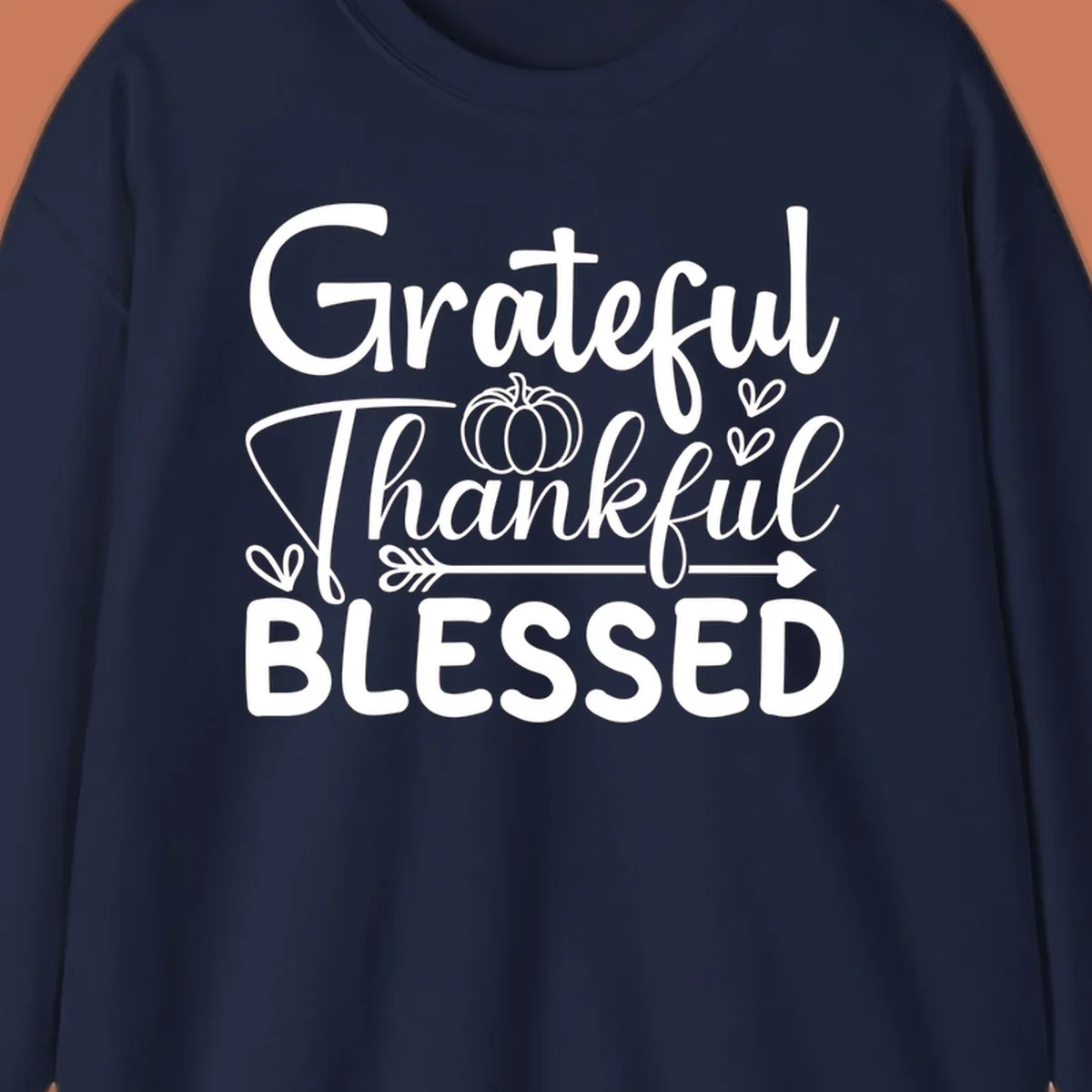 Grateful Thankful Blessed typography design with pumpkin, hearts, and arrow.