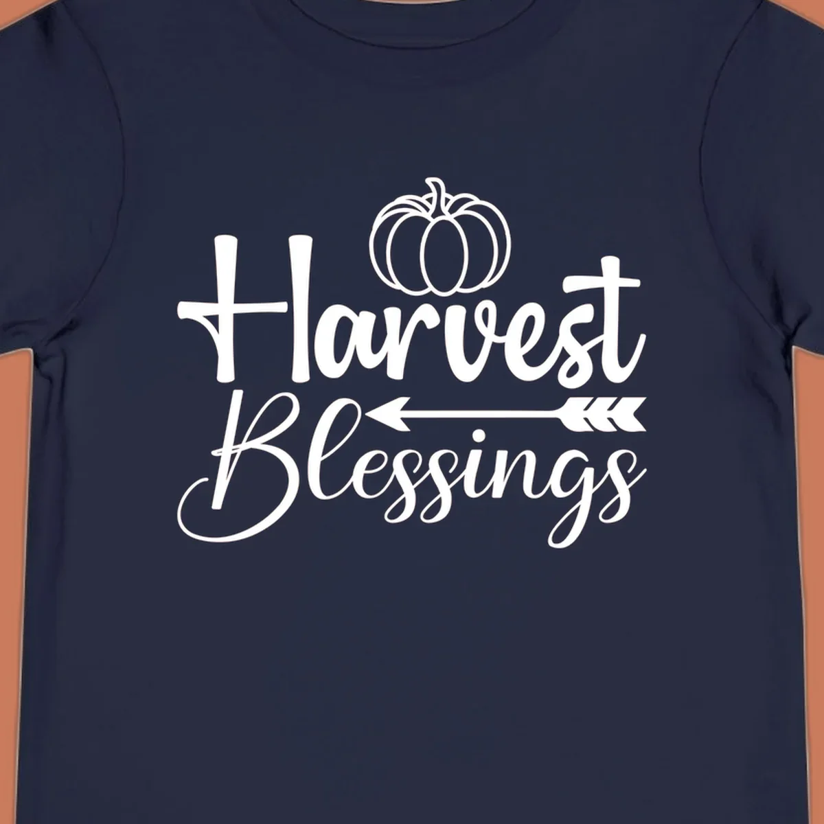 Harvest Blessings text with pumpkin and arrow illustration for autumn season.
