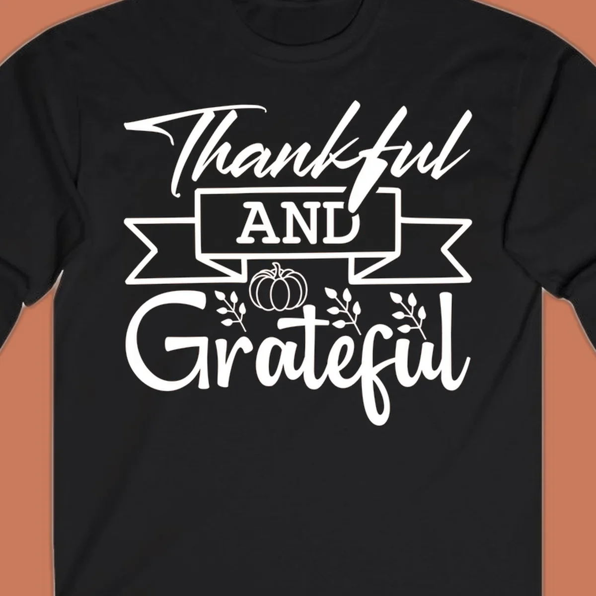 Thankful and Grateful autumn design with pumpkin and leaves.