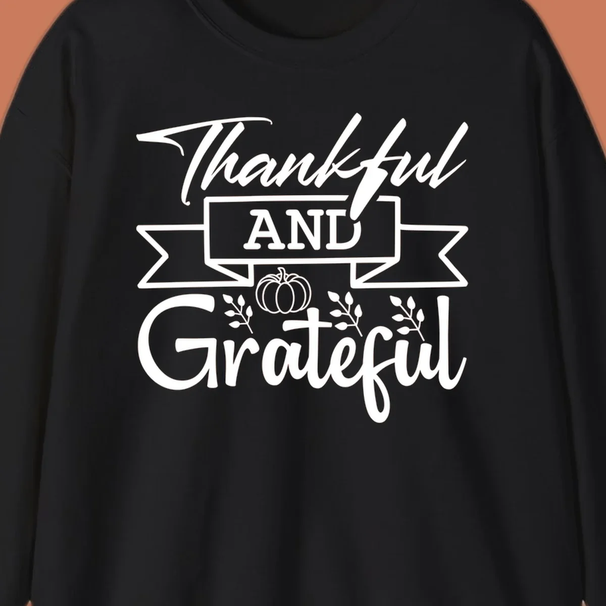 Thankful and Grateful autumn design with pumpkin and leaves.