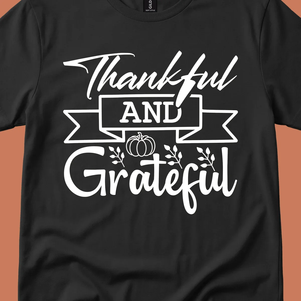 Thankful and Grateful autumn design with pumpkin and leaves.