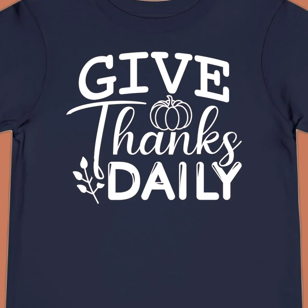 Give Thanks Daily text with a pumpkin and leaf sprig.