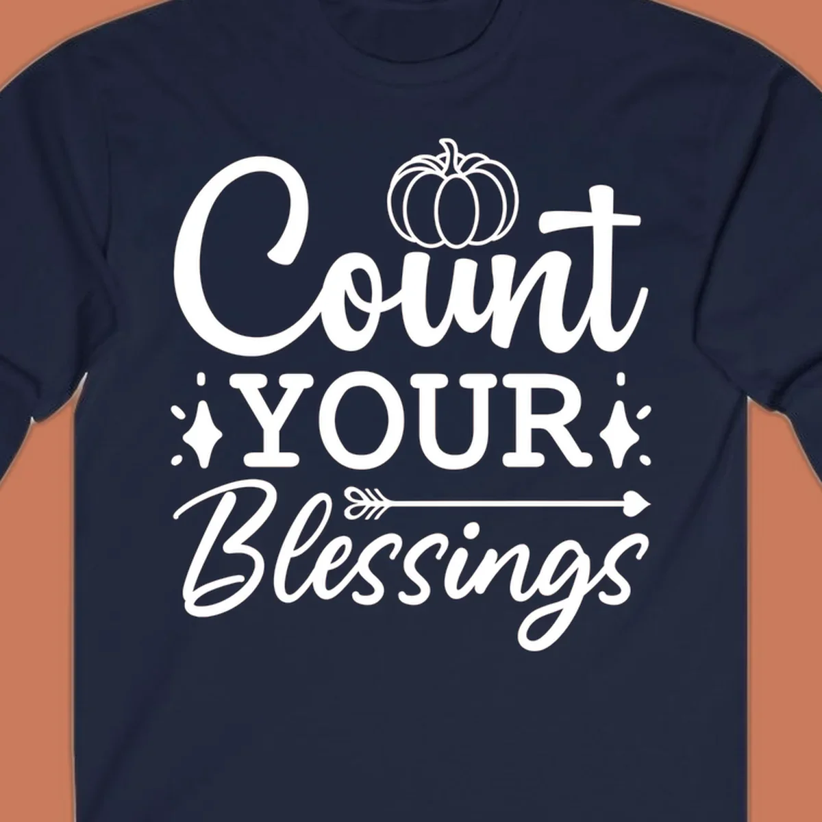 Count your blessings text with pumpkin and arrow graphic, in white.