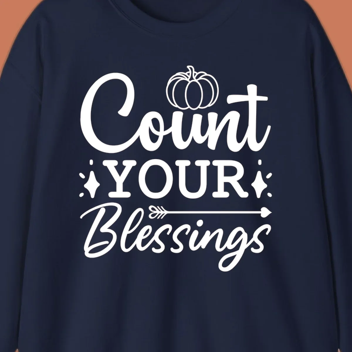 Count your blessings text with pumpkin and arrow graphic, in white.