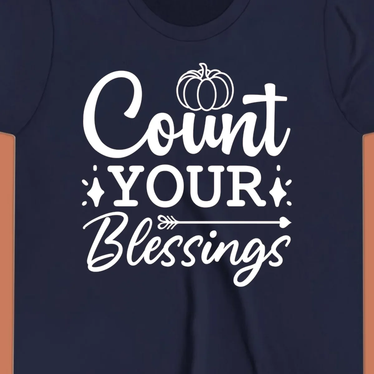 Count your blessings text with pumpkin and arrow graphic, in white.