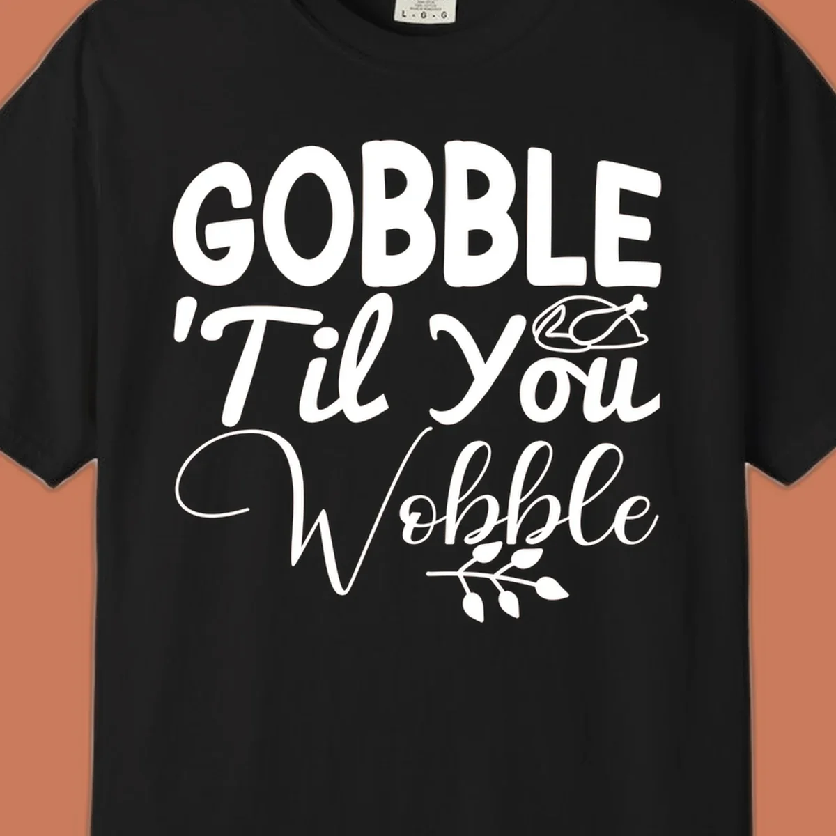 Gobble wobble thanksgiving phrase with roasted turkey illustration and leafy branch.