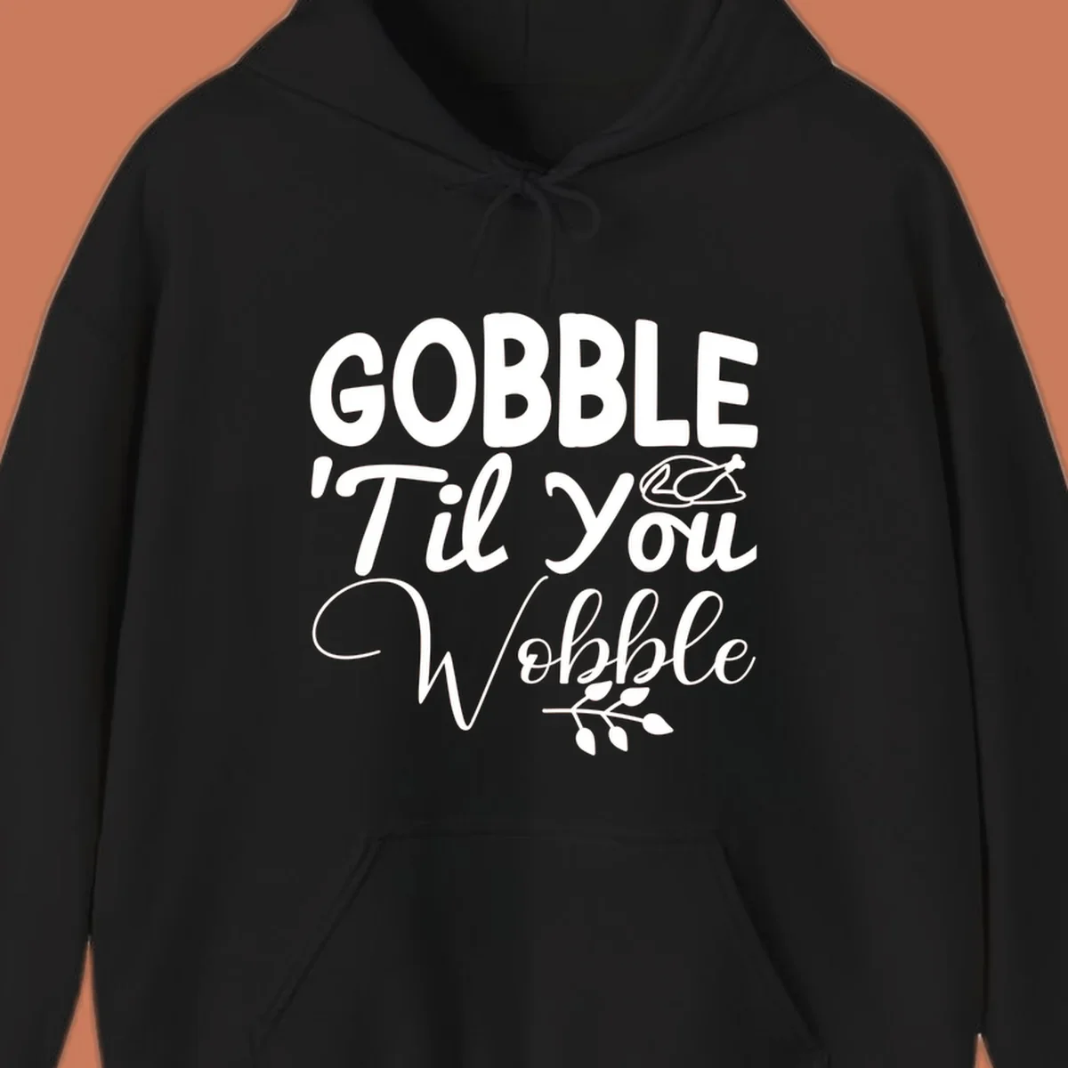 Gobble wobble thanksgiving phrase with roasted turkey illustration and leafy branch.