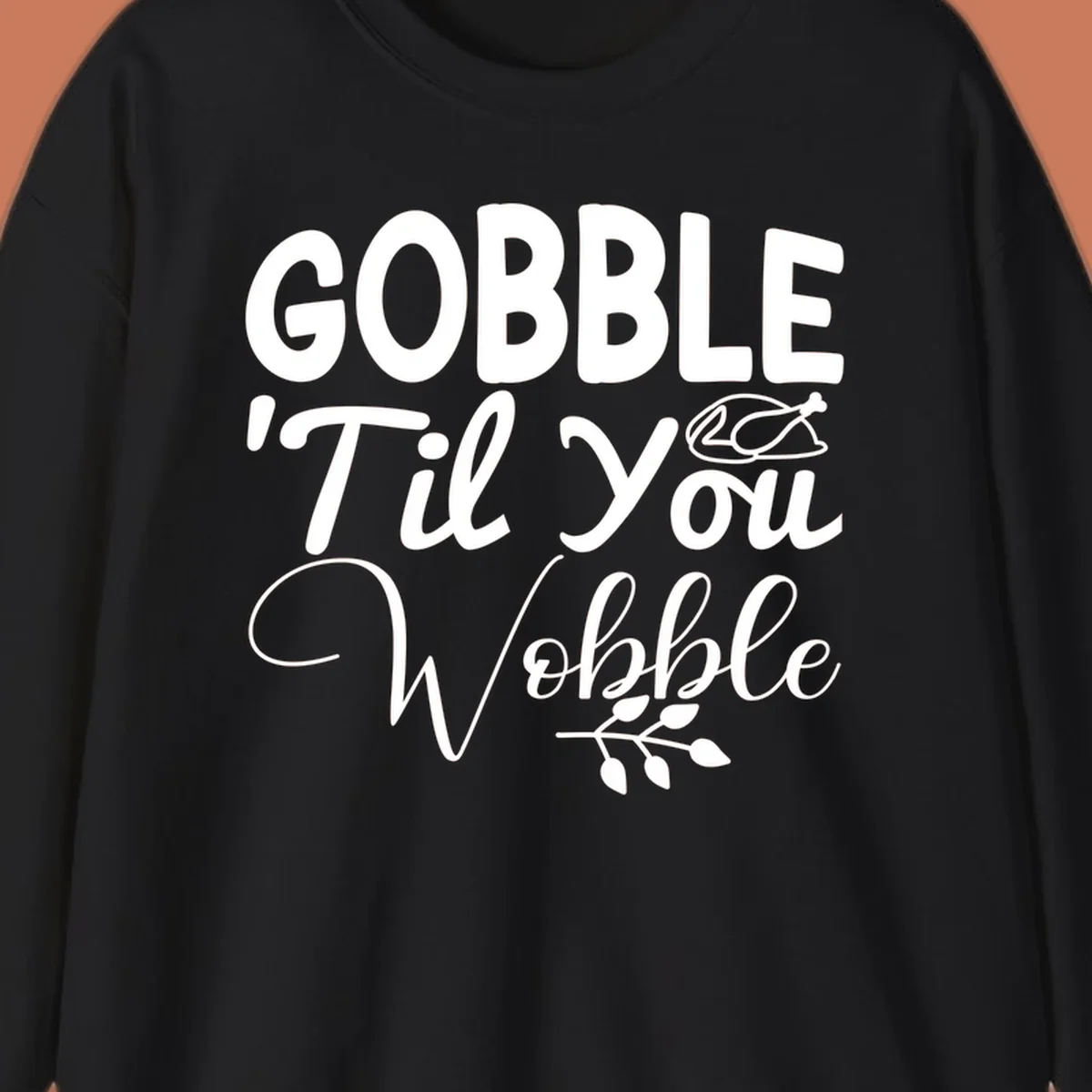 Gobble wobble thanksgiving phrase with roasted turkey illustration and leafy branch.