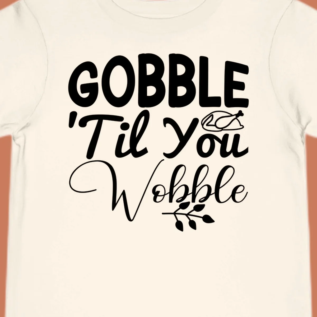 Gobble wobble thanksgiving phrase with roasted turkey illustration and leafy branch.