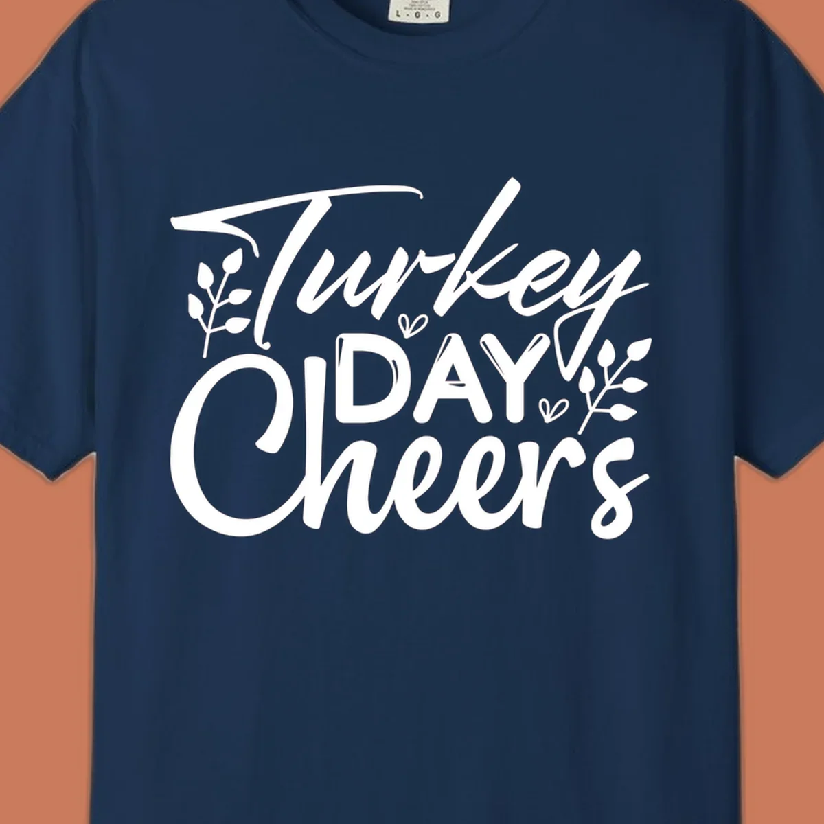 Typography design with "Turkey DAY Cheers" and decorative leaves, a Thanksgiving sentiment.