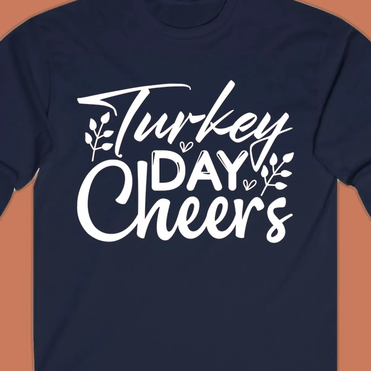 Typography design with "Turkey DAY Cheers" and decorative leaves, a Thanksgiving sentiment.