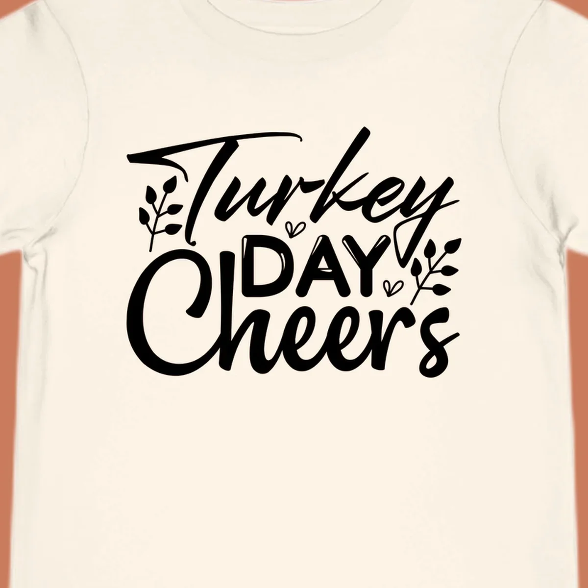 Typography design with "Turkey DAY Cheers" and decorative leaves, a Thanksgiving sentiment.