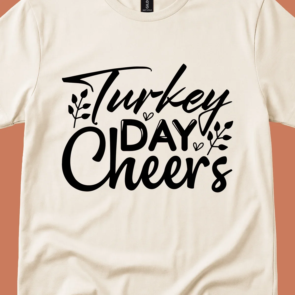 Typography design with "Turkey DAY Cheers" and decorative leaves, a Thanksgiving sentiment.