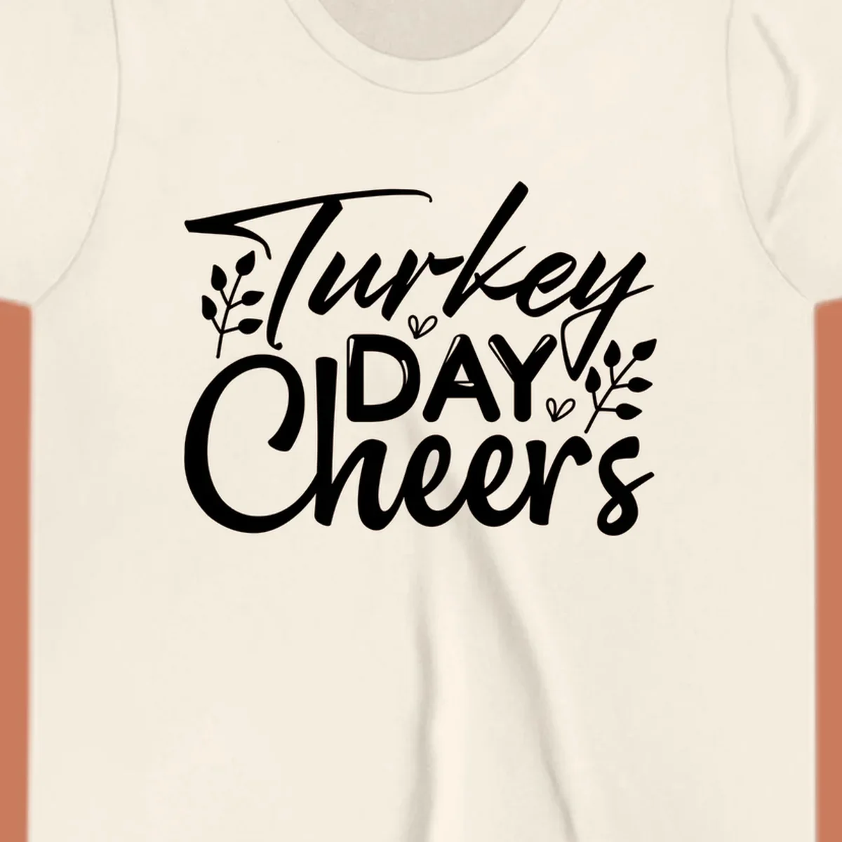 Typography design with "Turkey DAY Cheers" and decorative leaves, a Thanksgiving sentiment.