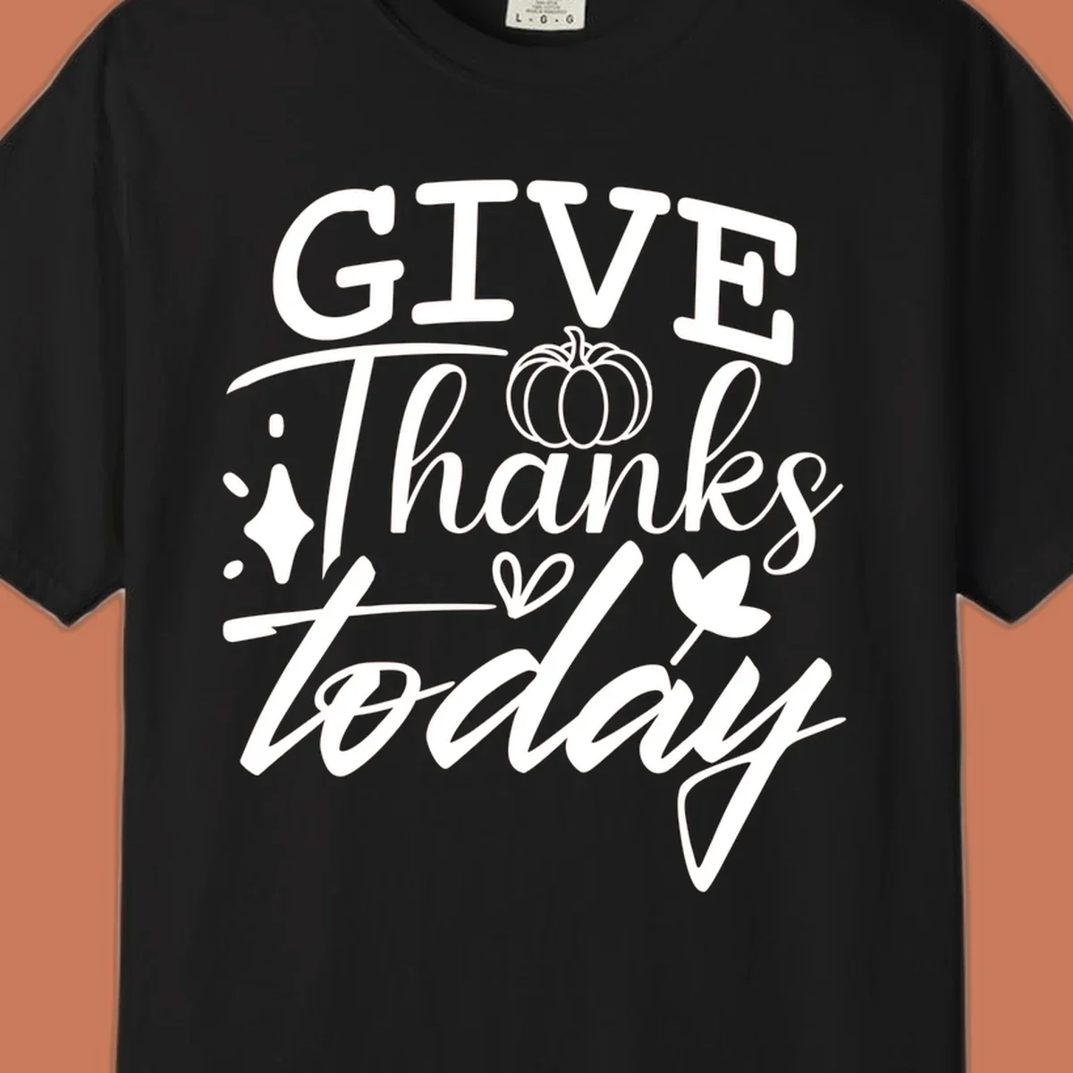 Give Thanks Today typography design with pumpkin and leaf elements.