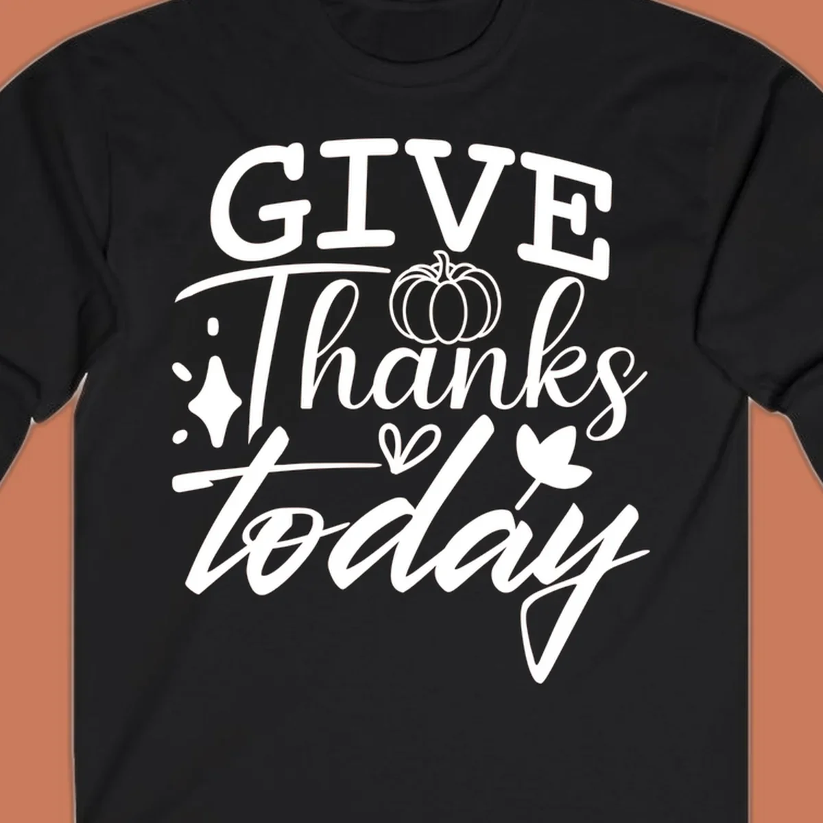 Give Thanks Today typography design with pumpkin and leaf elements.