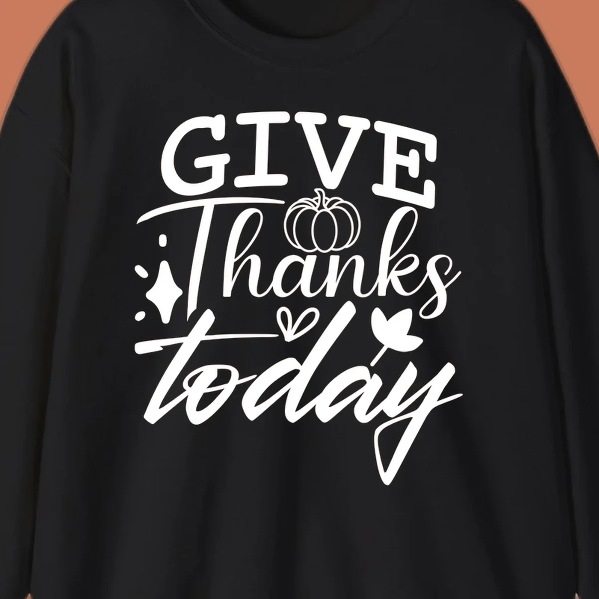 Give Thanks Today typography design with pumpkin and leaf elements.