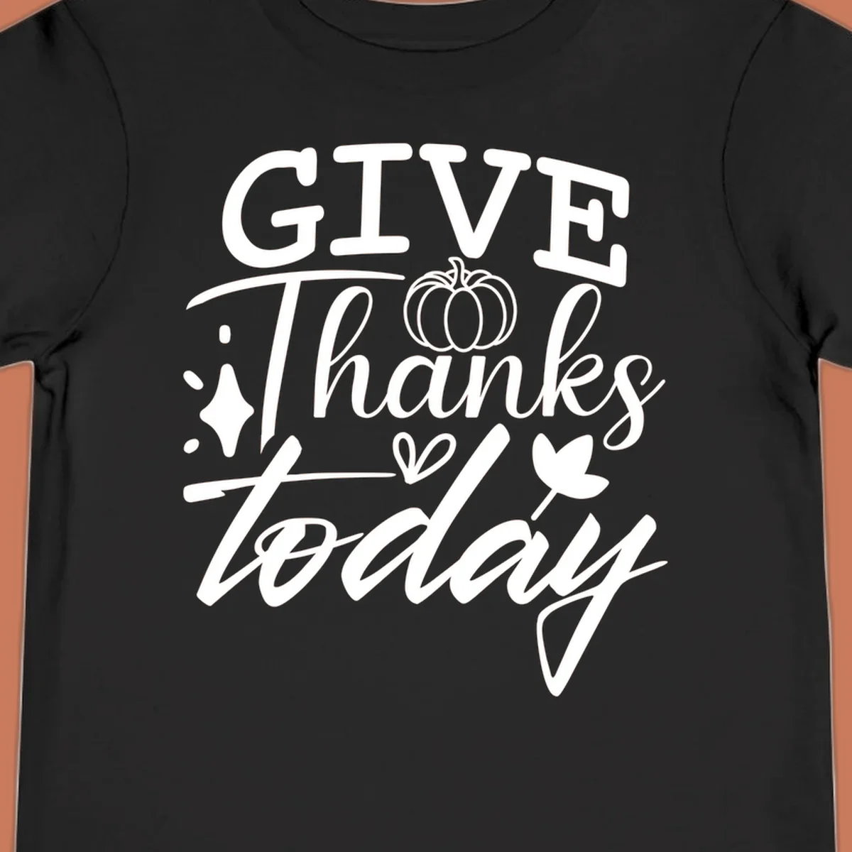 Give Thanks Today typography design with pumpkin and leaf elements.
