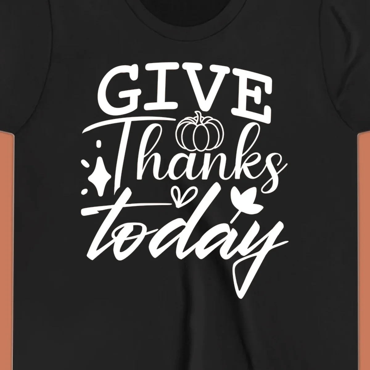Give Thanks Today typography design with pumpkin and leaf elements.