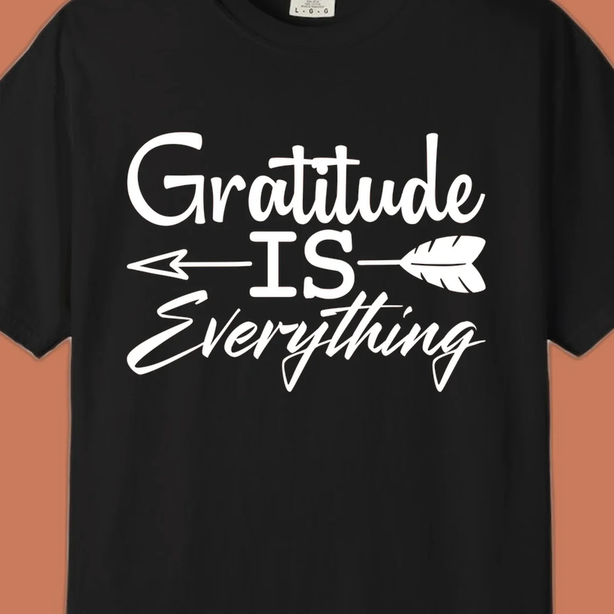 Gratitude Is Everything typography design with an arrow and feather graphic.