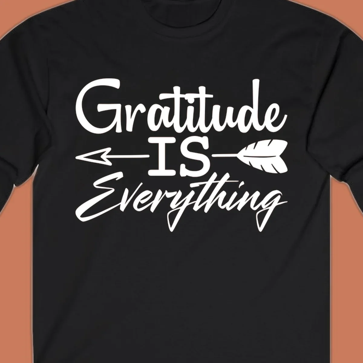 Gratitude Is Everything typography design with an arrow and feather graphic.