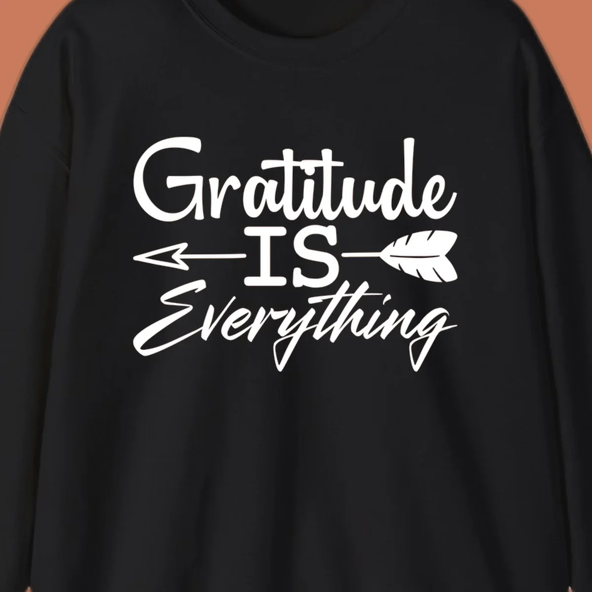Gratitude Is Everything typography design with an arrow and feather graphic.