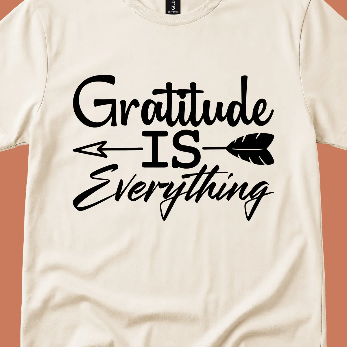 Gratitude Is Everything typography design with an arrow and feather graphic.