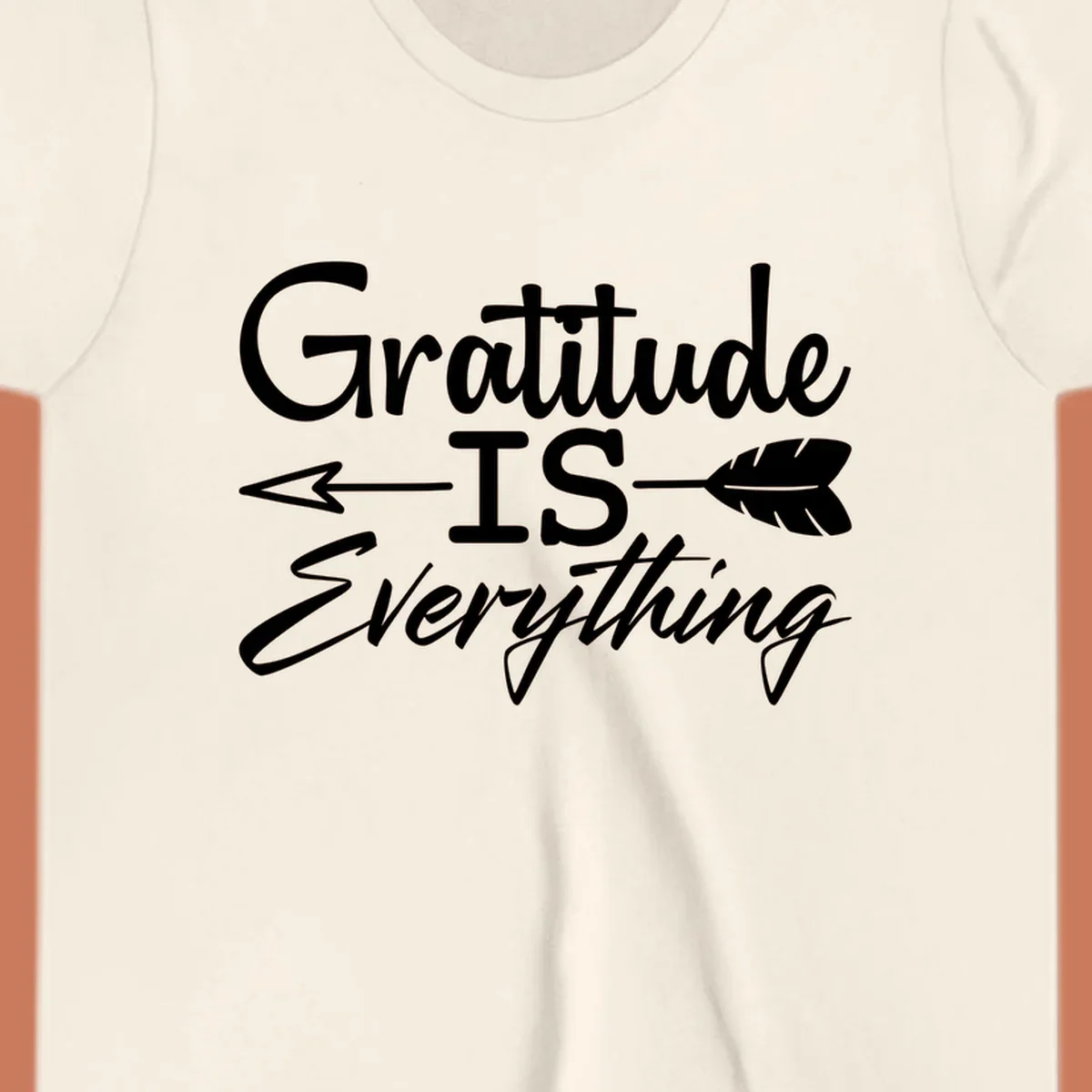 Gratitude Is Everything typography design with an arrow and feather graphic.