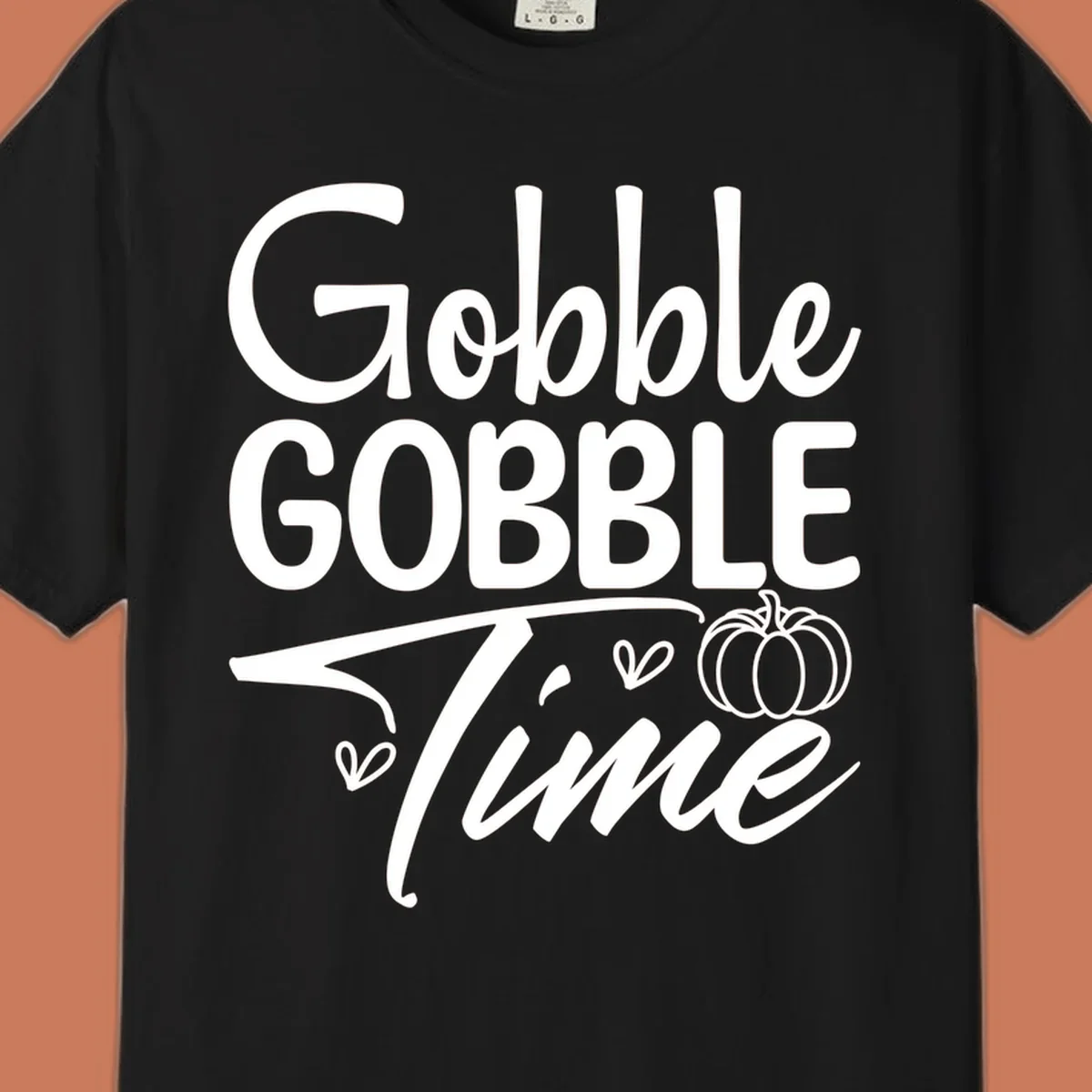 Gobble Gobble Time phrase with pumpkin and hearts, white typography on black background.