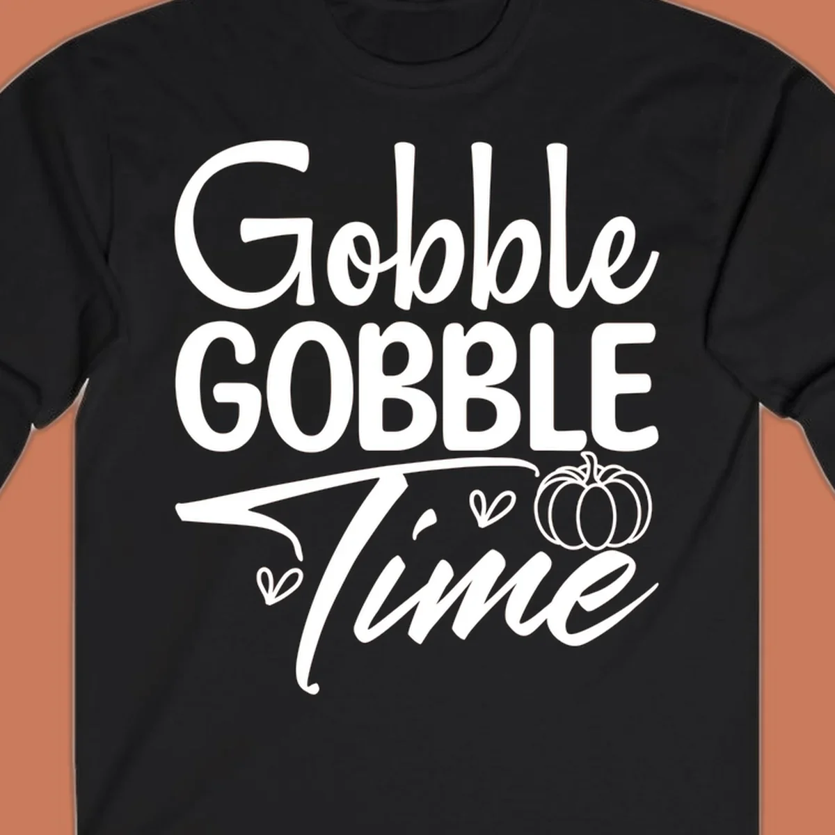 Gobble Gobble Time phrase with pumpkin and hearts, white typography on black background.