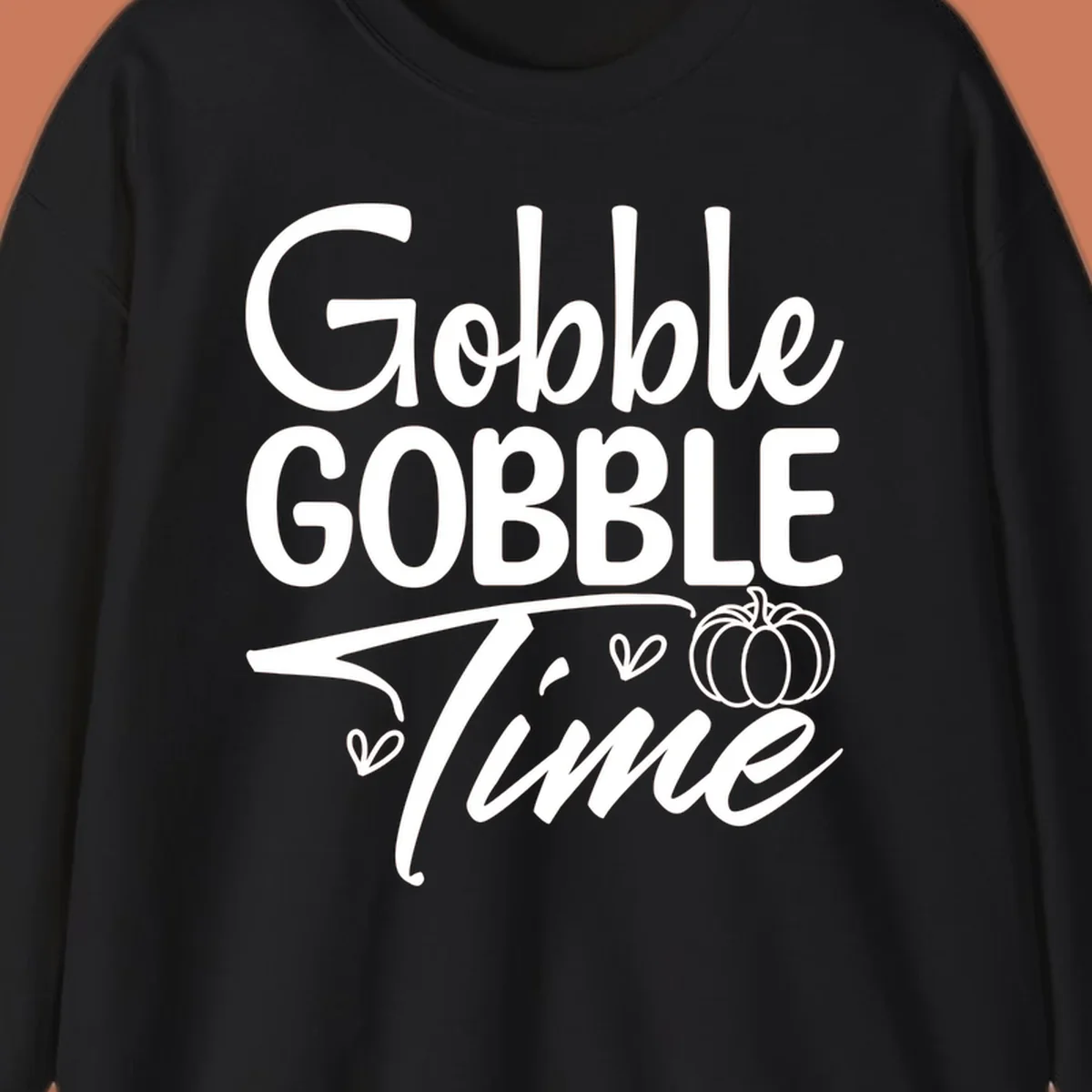 Gobble Gobble Time phrase with pumpkin and hearts, white typography on black background.