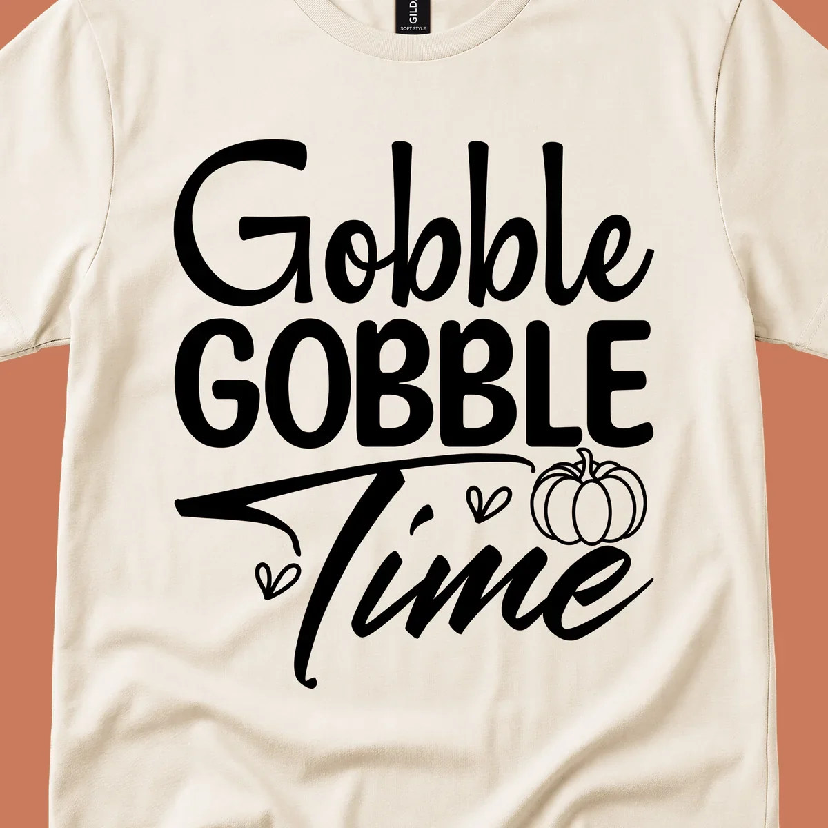 Gobble Gobble Time phrase with pumpkin and hearts, white typography on black background.